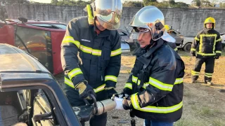 Governador Jorginho Mello cortando pedaço de carro com um alicate hidráulico