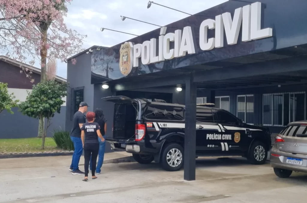 Mulher foragida sendo conduzida por policiais civis até a delegacia em Balneário Gaivota